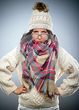 Grumpy young woman in winter fashion