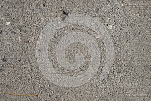 Grunge asphalt texture. Uneven concrete surface closeup. Weathered grungy surface photo background.