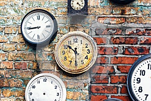 Grunge background with old watch. Time concept. Retro clocks on the wall. Old antique clock on aged red brick wall background.