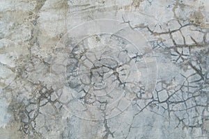 Grunge bare cracked concrete wall texture background.