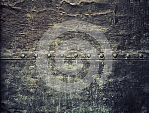 Grunge black metal plate with rivets screws background texture