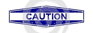 Grunge blue caution word hexagon rubber stamp on white background