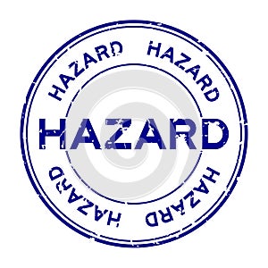Grunge blue hazard word round rubber stamp on white background
