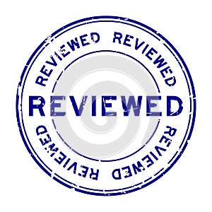 Grunge blue reviewed word round rubber stamp on white background