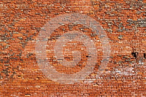 Grunge brick background with various colored bricks and remnants of white paint and a few missing or damaged - interesting design