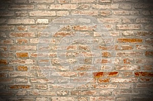Grunge brick wall background with vignetted corners