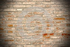 Grunge brick wall background with vignetted corners photo