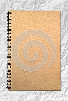 Grunge brown cover notebook on wrinkled paper