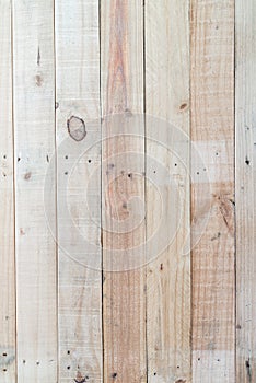 Grunge brown wood wall background with knots and nail holes