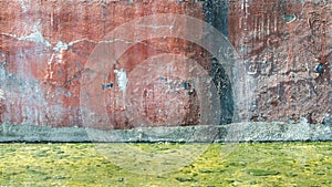 Grunge concrete wall and green polluted water at ground