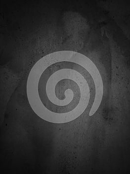 Grunge and concrete wall pattern with dark and bright tones in the center for a black background.