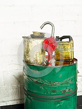 Grunge dirty oil drum, spout and buckets.