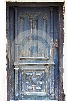 Grunge door painted in blue worn and weathered