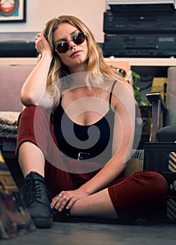 Grunge fashion, punk woman and rock hipster, retro model and confident female with glasses on floor. Portrait of young