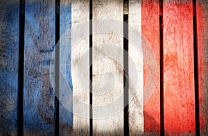 Grunge filtered,France national flag on wood background.