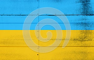 Grunge flag of Ukraine on studded metal