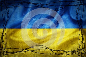 Grunge flag of Ukraine surrounded by barb wire illustration