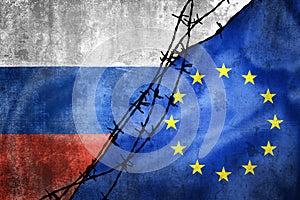 Grunge flags of Russia and European Union and Poland divided by barb wire illustration
