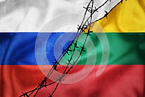 Grunge flags of Russian Federation and Lithuania divided by barb wire illustration