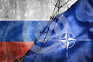 Grunge flags of Russian Federation and NATO divided by barb wire illustration