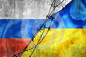 Grunge flags of Russian Federation and Ukraine divided by barb wire illustration