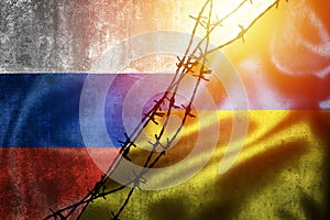 Grunge flags of Russian Federation and Ukraine divided by barb wire illustration