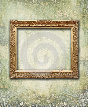 Grunge floral faded wallpaper with golden antique empty frame