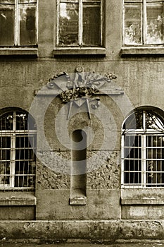 Grunge freemasonry emblem on a dramatic background - masonic triangle and compass, closeup of old architectural building