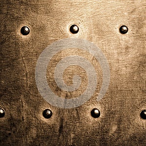 Grunge gold brown metal plate rivets screws background texture