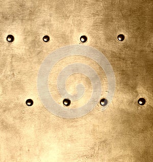 Grunge gold brown metal plate rivets screws background texture