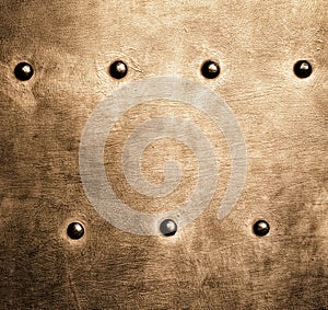 Grunge gold brown metal plate rivets screws background texture