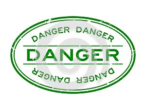 Grunge green danger word oval rubber stamp on white background