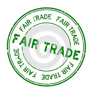 Grunge green fair trade word round rubber stamp on white background
