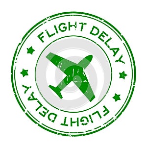 Grunge green flight delay word with airplane icon round rubber stamp on white background
