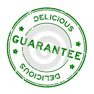 Grunge green guarantee delicious word rubber seal stamp on white background