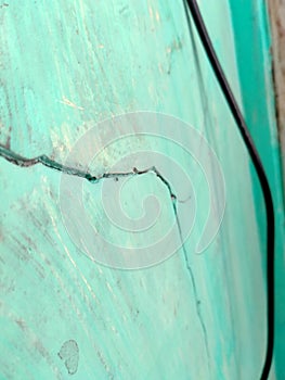 The grunge green wall background surface is occurring on the building of the house