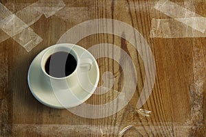 Grunge image of cup of coffee on table