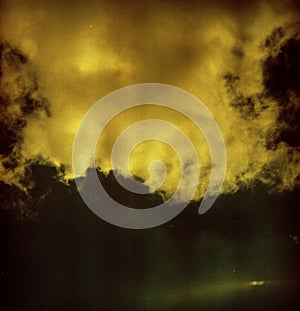 Grunge image of sky with a cloud on grainy film texture