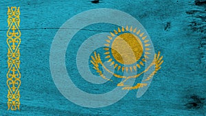 Grunge Kazakhstani flag texture, A gold sun above eagle on blue field and national ornamental pattern.