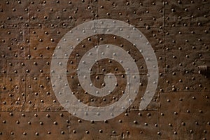 Grunge metal wall with rivets. Rusty metal or iron texture or background. Blank or template in retro style