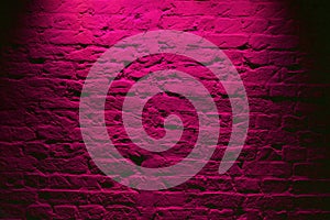 Grunge neon pink brick wall texture background. Magenta colored brick wall texture architecture pattern