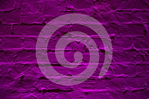 Grunge neon purple brick wall texture background. Magenta colored brick wall texture architexture pattern