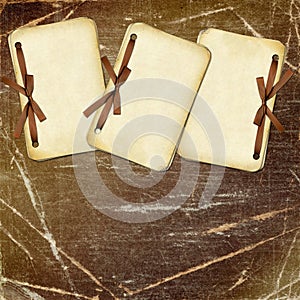 Grunge papers with bow on dark background