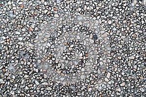 Grunge pebble floor as seamless textured background.Small pebbles mixed with sand texted background