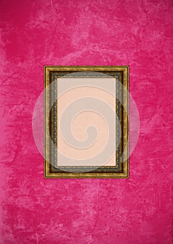 Grunge pink stucco wall with empty picture frame