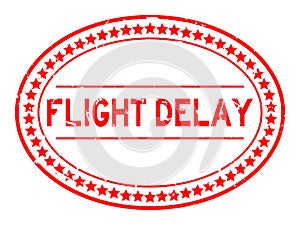 Grunge red flight delay word oval rubber stamp on white background
