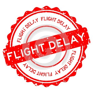 Grunge red flight delay word round rubber stamp on white background