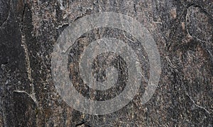 Grunge rough black stone texture background. Rusted peeled black stone. Abstract fragment wall texture