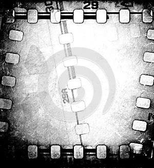 Grunge scratched dirty film strip background with reel.