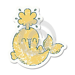 grunge sticker of tattoo style happy squirting whale character